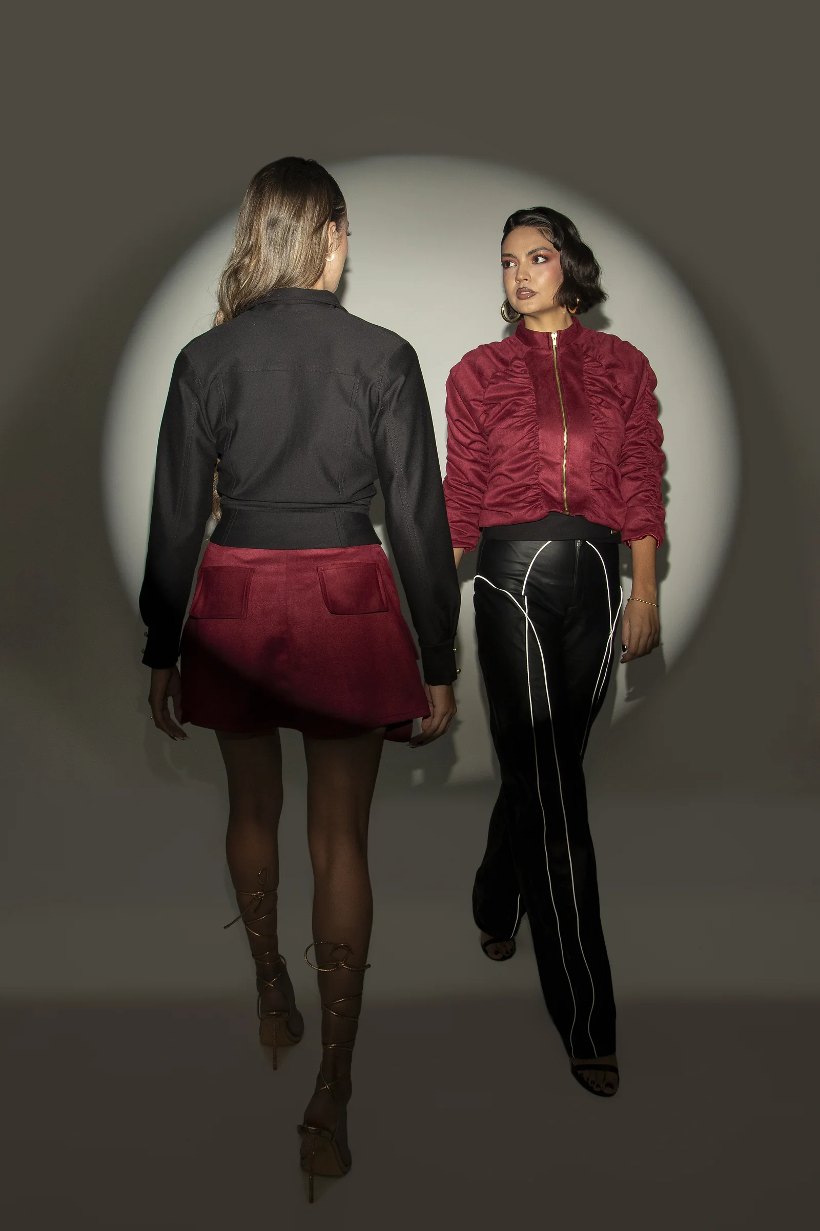 Dos modelos presentan prendas negras y rojas de la colección Louva